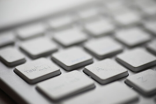 Close-Up of White Computer Keyboard Keys in Minimalist Office Setting