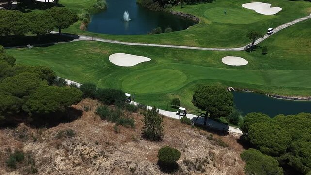 Golfers on the golf course, aerial view.