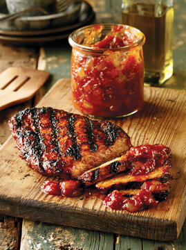 Grilled Barbecue Chicken with Spicy Sauce on Wooden Board. AI generative.
