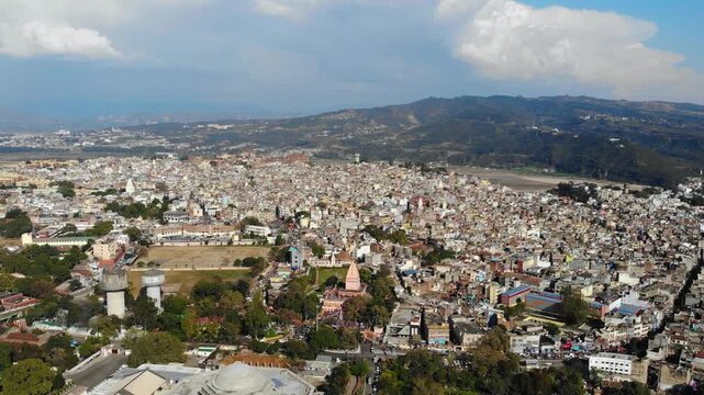 Panoramic drone shot over the sprawling Old City of Jammu and Tawi River.