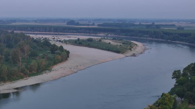 Broad alluvial bars and vegetated islands divide the river into multiple channels as prolonged summer drought reduces discharge, exposing fresh sediment across one of Europe's largest river floodplain