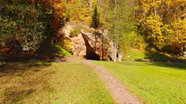 Drone Approach to Historic Gutman Cave Beneath Golden October Woodland