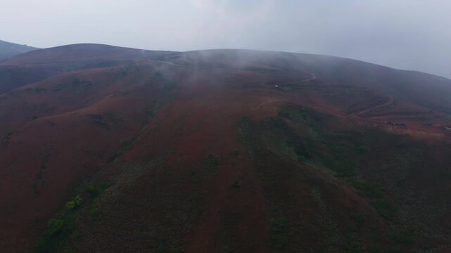 Chandra Drona Parvatha with fog, sky and mud pathway at Baba Budan giri, Western Ghats, Chikkamagaluru, Inam Dattathreya Peeta, karnataka, india. day time, push in shot, drone shot, 4k.