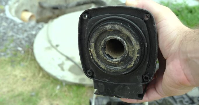 Close-up of heavy limescale deposits inside a pump motor housing during maintenance inspection. Concept of hard water damage, pump repair, descaling, and mechanical servicing.