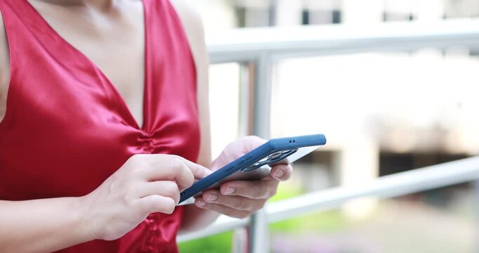 woman in a red dress using a smartphone, mobile and technology, communication, social media, online lifestyle, and connectivity, close-up