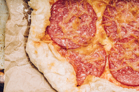 Homemade rustic pizza with sausage and cheese. Shot from above.