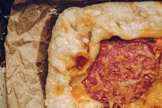 Homemade rustic pizza with sausage and cheese. Shot from above.