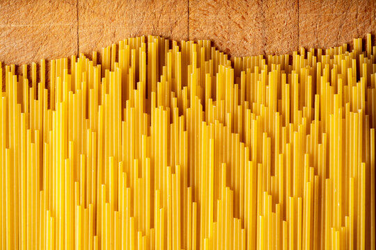 Dry spaghetti as textured background. Shot from above. Background and textures.