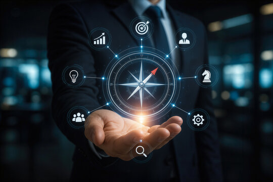 Businessman holding glowing digital compass with navigation strategy icons for leadership planning corporate direction vision and decision making in dark office environment