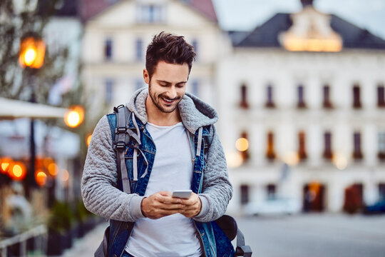 Man using phone at the evening in the city