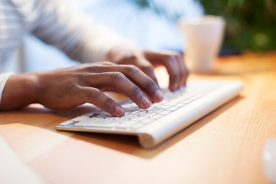 Man's hands typing on computer keyboard