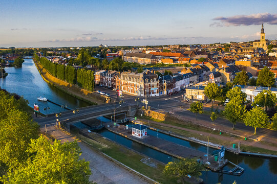 France, Nord, Cambrai, Aerial view of river Scheldt flowing in Canal de Saint-Quentin with city buildings in background