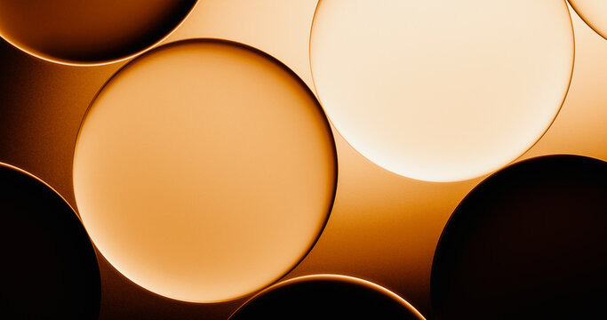 Warm light illuminates abstract glass circles in a modern background