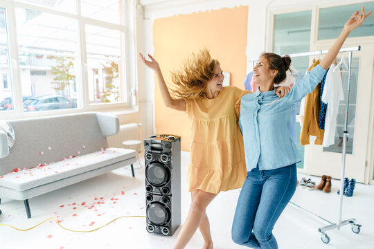Two excited young women having a party
