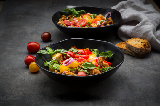 Panzanella made of roasted Ciabatta, rocket, red onions, tomatoes and basil