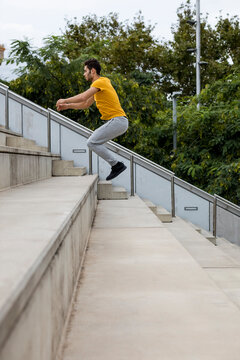 Young man during workout jumping on step