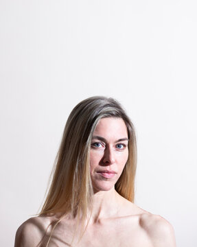 Studio portrait of woman looking at camera against white background