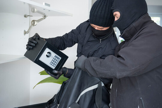 Two burglars at work in an one-family house at daytime