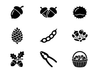 Black and white vector icon set of various nuts seeds acorn pine cone and a nutcracker tool © alien AZ