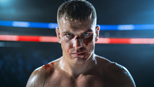 MMA Fighters Battle in a Hard Fight Inside the Cage as a Bloodied Fighter Stares Forward, Showing Contact,  Competitive Fight for the Champion Title Belt Show, Raw Martial Arts Actio.