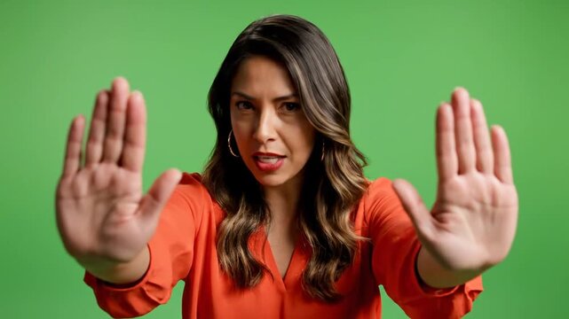 Angry Woman Showing Stop Gesture Isolated on Green Screen Background