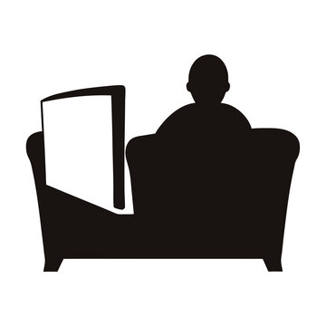 Silhouette of person relaxing on couch reading a newspaper or book
