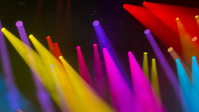 abstract background with colorful stage lights and beams at music festival