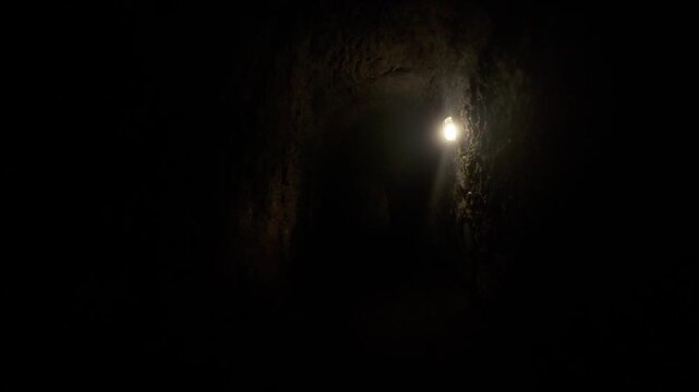 Ominous move forward through a dark cave. Moody and cinematic. Balinese cave near Ulu petanu waterfall. 
