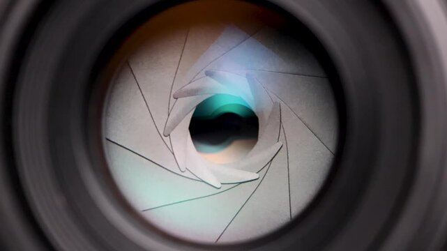 Close-up macro shot of a camera lens aperture smoothly closing from its widest to its narrowest setting, showcasing the precision of optical mechanics and exposure control