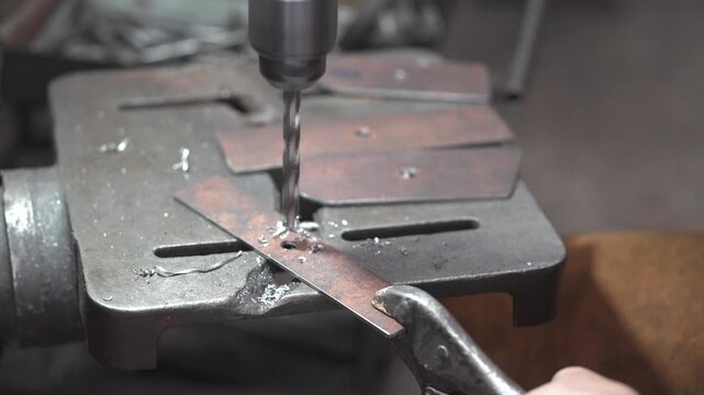 Skilled Machinist Operating Drill Press Machine in Small Community Metalworking Workshop