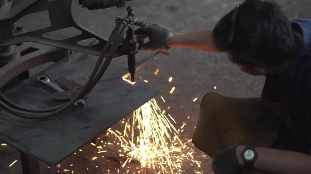 Experienced Machinist Cutting Steel with Industrial Metal Cutting Machine in Local Engineering Workshop	