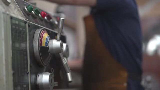 Close up of Drill Press Machine with Skilled Machinist in background