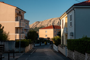 Obraz premium Idyllic Croatian coastal town street with Mediterranean architecture and mountains