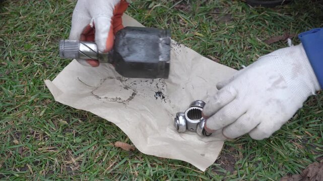 Mechanic Hands Examining CV Joint Tripod Journal Bearing, Car Repair Process Showing Inner CV Joint Spider Bearing