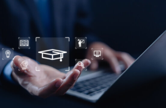 Business professional using digital e-learning platform with online education, virtual classroom, knowledge management, skills training, and remote learning technology for professional development.