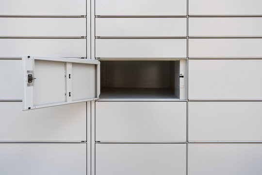 Automated parcel locker with an open empty cell close up. Modern self service post terminal station for mail package delivery. Smart contactless pickup box storage concept for e-commerce.