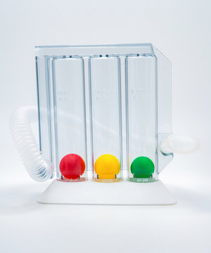 Triple chamber incentive spirometer for deep breathing exercises, respiratory therapy and lung rehabilitation after surgery, medical device used to improve pulmonary function and recovery.