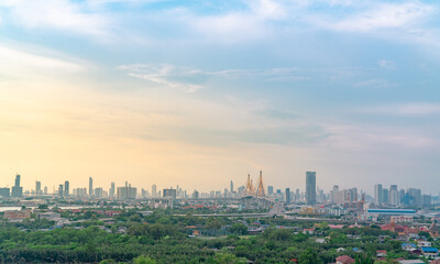 Naklejka premium Cityscape of modern building with highway and community in Bangkok. Car driving on elevated bridge. Skyscraper building. Green trees in city. Oxygen for urban life. Eco-friendly city. Urban skyline.