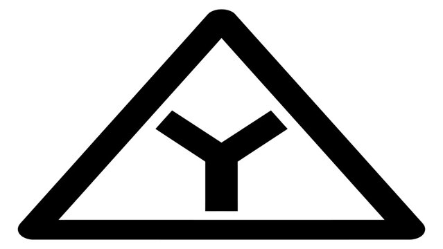 Warning sign displaying a y-shaped intersection informs motorists of an upcoming road split.