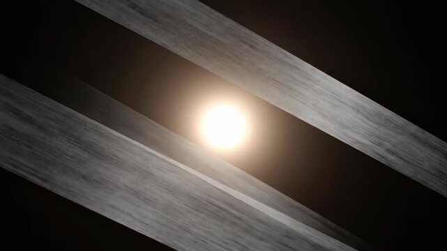 Bright light source with diagonal motion streaks on dark background