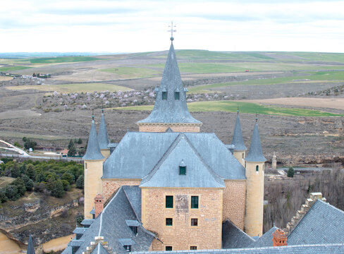 Roofs and towers of the Alcazar of Segovia overlooking the Castilian countryside, Spain