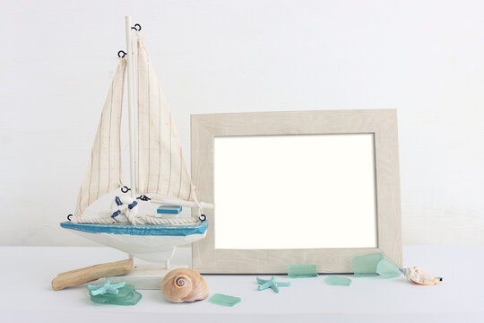 summer background with boat, blue sea glass and shells