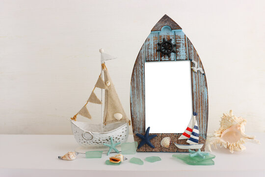 summer background with boat, blue sea glass and shells