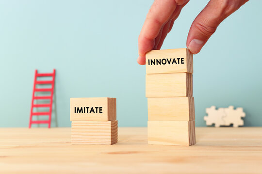 Choosing innovation instead of imitation concept. wooden cubes with text