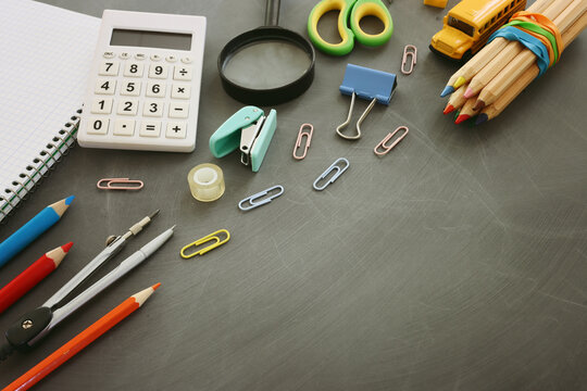Back to school concept over classroom blackboard. Top view