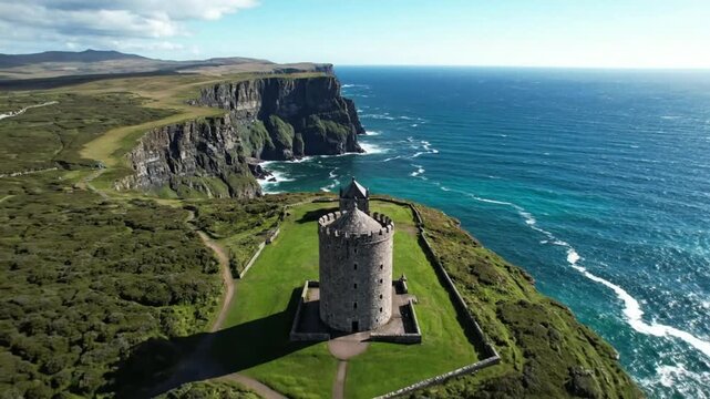 Drone perspective of historic O'Brien's Tower at the Cliffs of Moher in Ireland under a bright blue sky