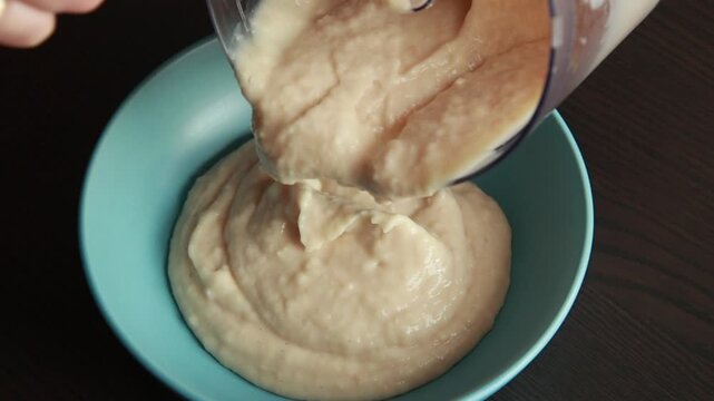 Smooth White Bean Puree Dip Garnished and Served in Ceramic Bowl