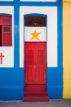 Colorful colonial facade with a red door and a star, Olinda, Pernambuco, Brazil