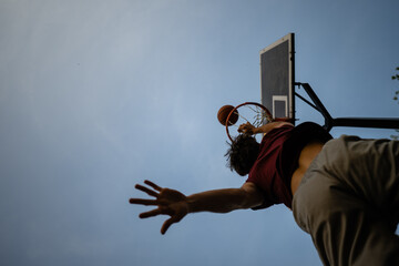Athlete performing slam dunk during basketball game © Zoran Jesic