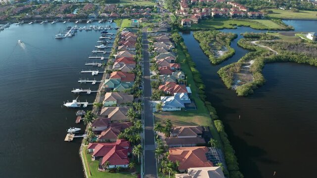Vibrant homes with private docks lining a peaceful canal. Ideal for real estate promotions or lifestyle content.
